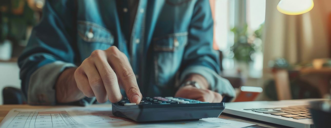 Person using a financial calculator, planning their savings and investments